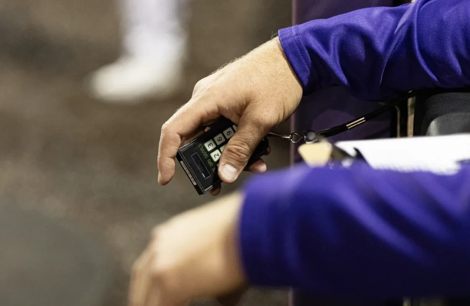 JMU Baseball Coach using the Game Day Signals Coaching Unit to send electronic call signals to every player on the field.